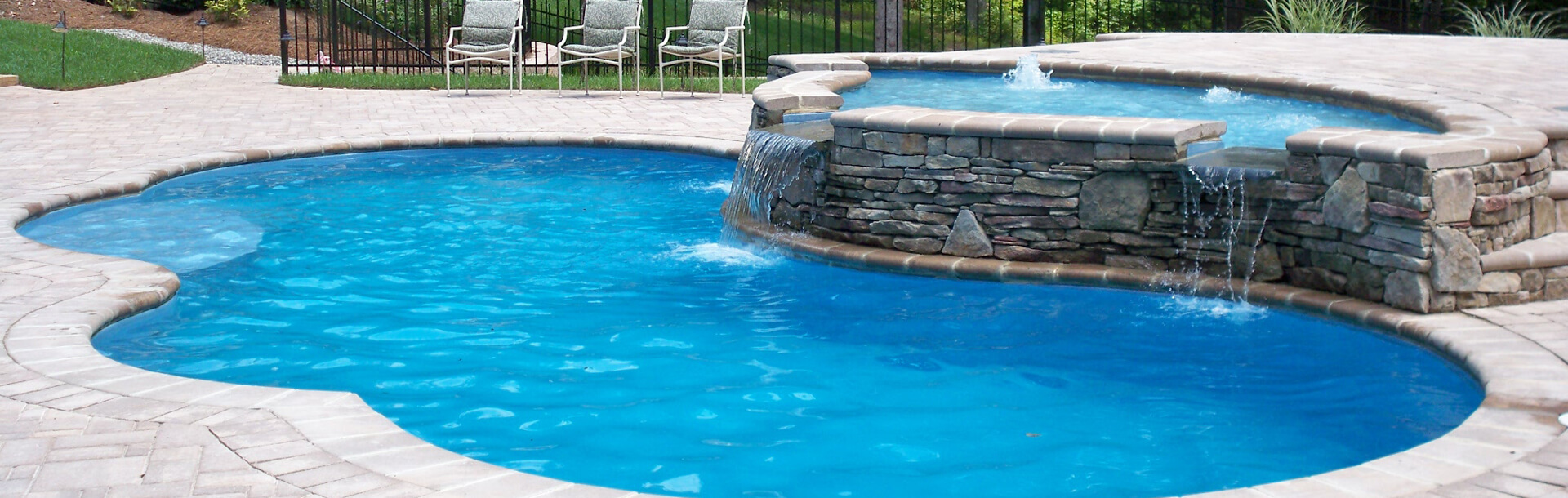 aquacade outdoor inground pool with waterfall and fountain