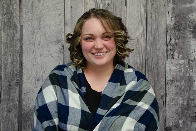 Headshot of Brittany Brideau wrapped in a blanket with her signature