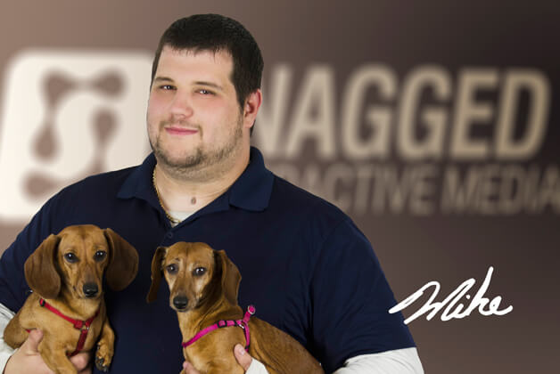 Headshot of Mike Lafrenière holding his dogs with his signature